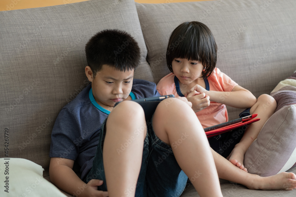 two children addicted tablet, asian kid watching cartoon
two children addicted tablet, asian kid watching cartoon