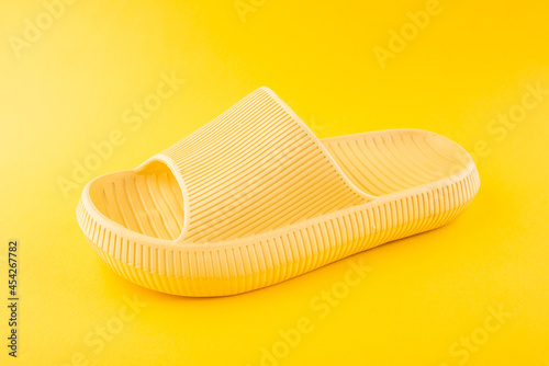 Yellow slippers on yellow background