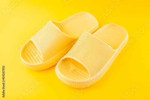 Yellow slippers on yellow background