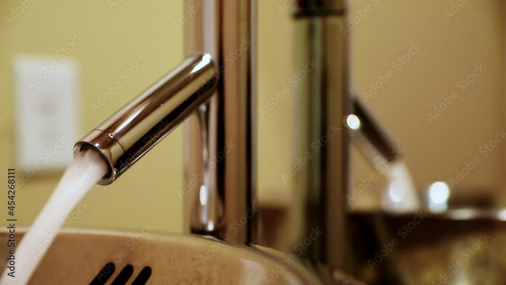 Water Rushes Out Of Hotel Bathroom Faucet On Sink. - Close Up Shot Water Rushes Out Of Hotel Bathroom Faucet On Sink. - Close Up Shot