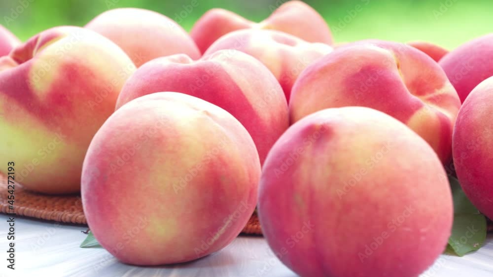 Fresh peach on blurred greenery background, Peach fruit on wooden table in garden. Fresh peach on blurred greenery background, Peach fruit on wooden table in garden.
