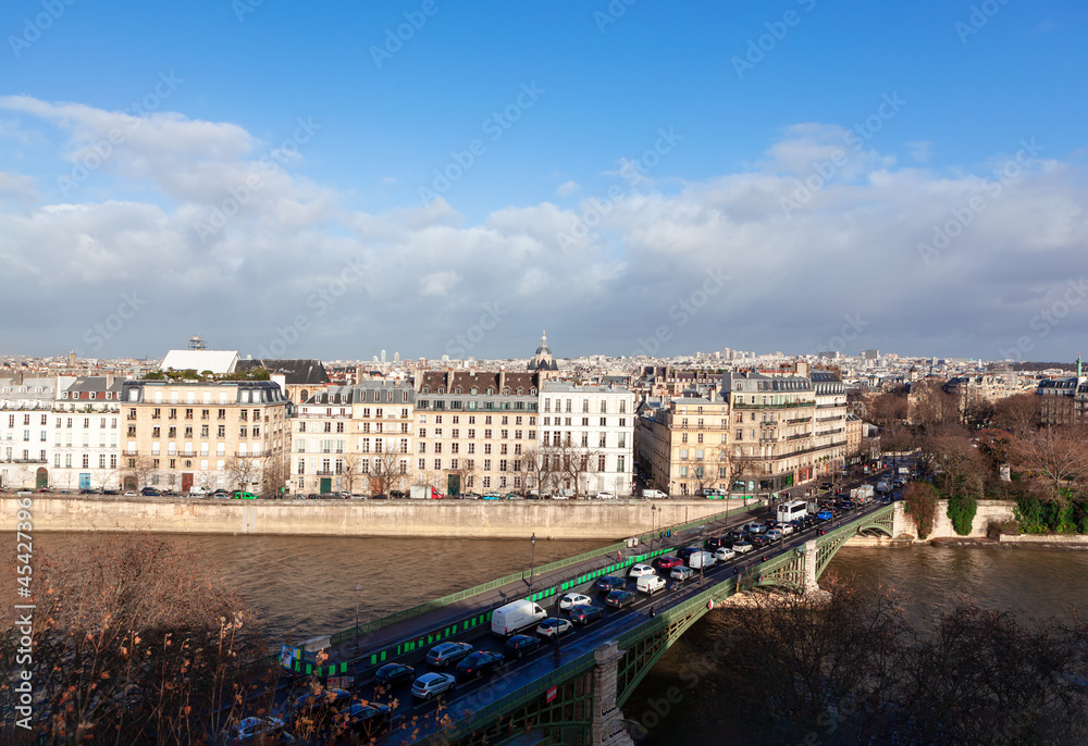 Morning Traffic jam in Paris . Cars in a traffic  jam on the Sully Bridge . Residential district at Ile Saint-Louis at Seine riverside in Paris 
