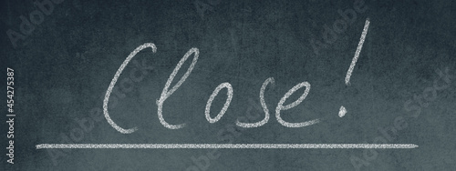 The word close standing on a blackboard, handwritten with chalk