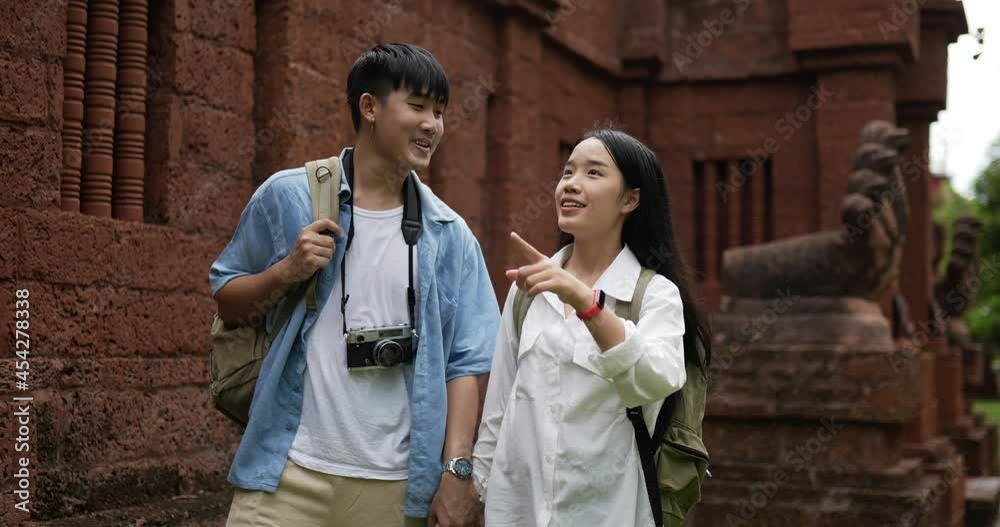 Couple hand together while visiting at ancient temple Couple hand together while visiting at ancient temple