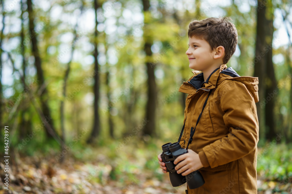 Portrait of boy who is hiking in nature with binoculars in autumn. Portrait of boy who is hiking in nature with binoculars in autumn.