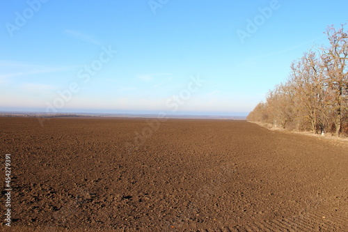 Plowed agricultural field with traces of agricultural machinery