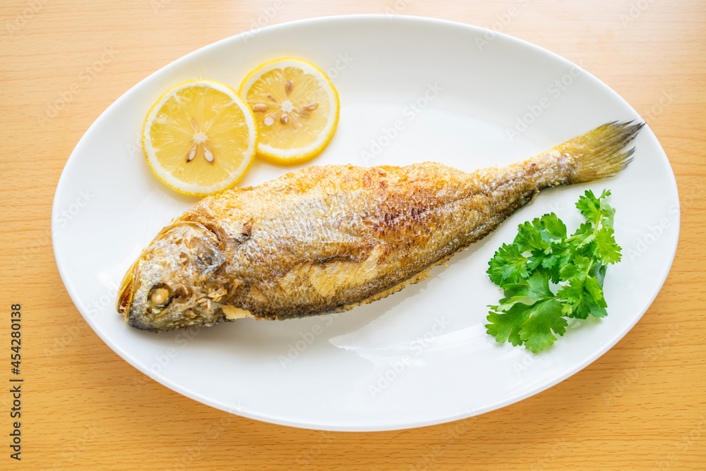 A fried yellow croaker on the table