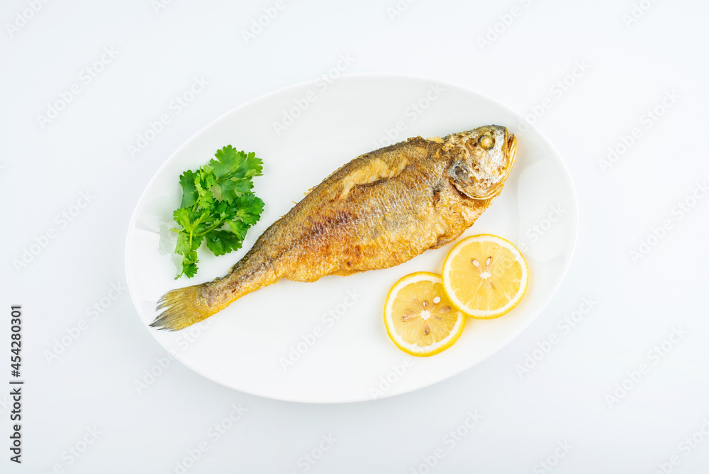 A fried yellow croaker on white background A fried yellow croaker on white background