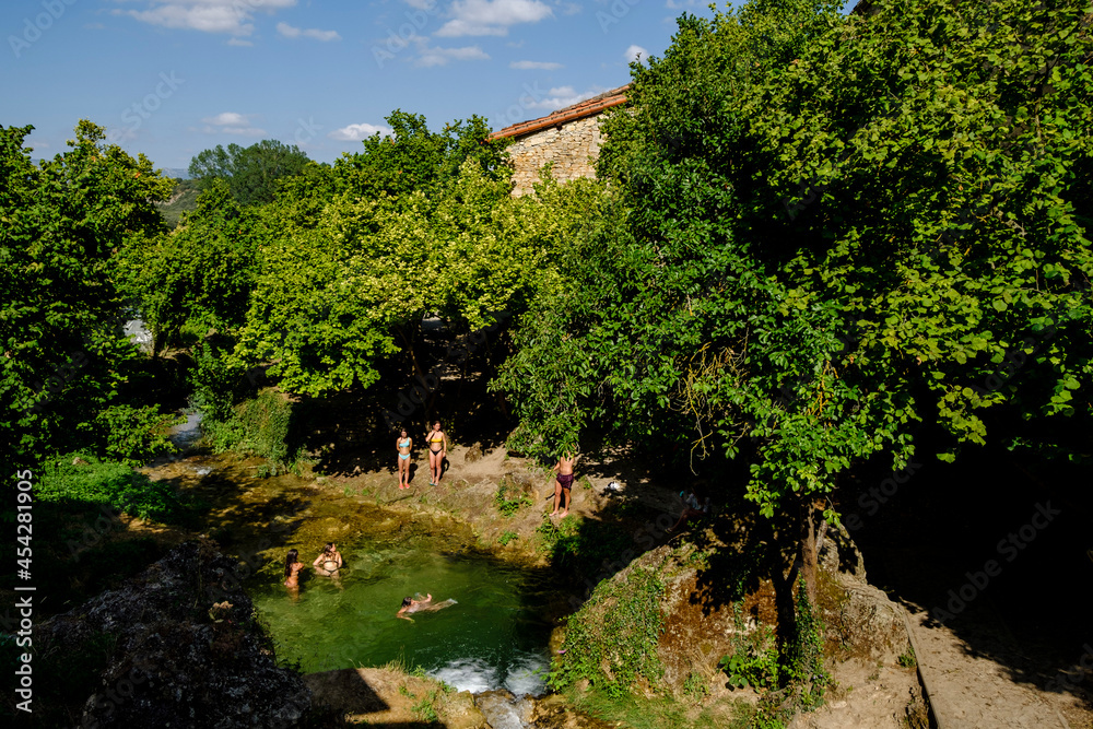 group of bathers cooling off, Molinar river, Tobera, town of the Burgos municipality of Frías, Autonomous Community of Castilla y León, Spain - obrazy, fototapety, plakaty 