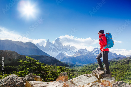 Active hiker hiking, enjoying the view, looking at Patagonia mountain landscape. Fitz Roy, Argentina. Mountaineering sport lifestyle concept