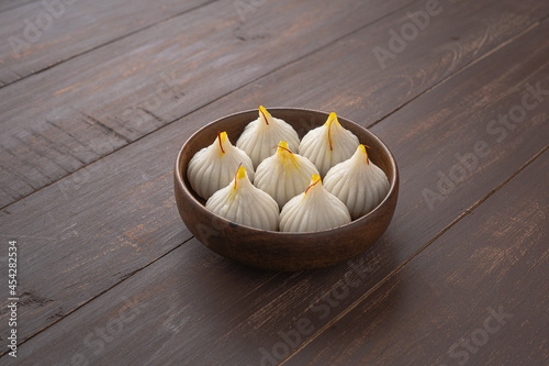 Steamed Modak, ukdiche modak, white modak made from rice flour and coconut jaggery filling. Modak is a traditional Indian sweet made during Ganesh Utsav and also offered to Lord Ganesha. photo