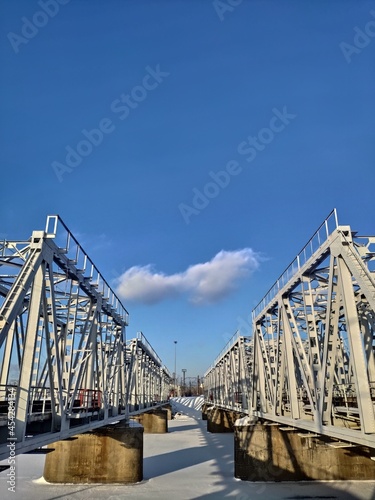 Photo of two adjacent bridges against a blue sky background