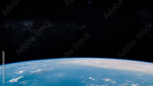 Falling stars in sky view from satellite over rotating earth planet horizon. Images furnished by Nasa