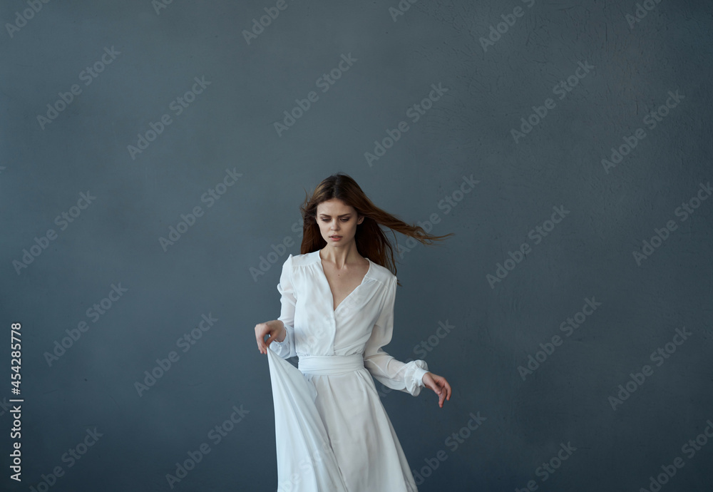 pretty red-haired woman in a white dress fun dance dark background pretty red-haired woman in a white dress fun dance dark background