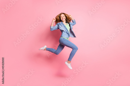 Fototapeta Naklejka Na Ścianę i Meble -  Full size profile side photo of young cheerful girl happy positive smile jump go walk run isolated over pink color background