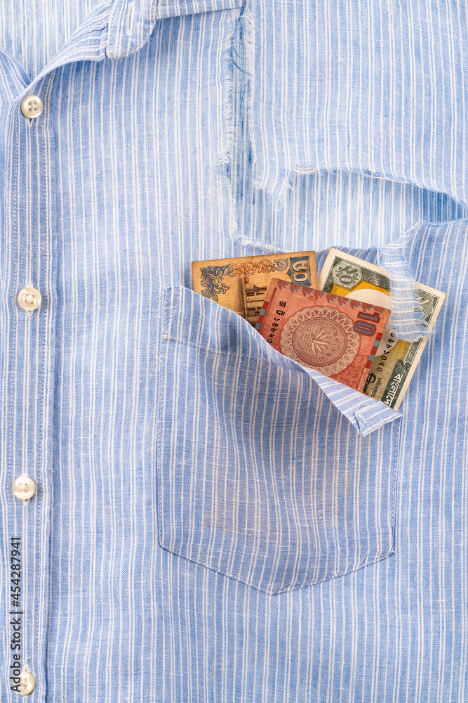 Ripped shirt pocket with last remaining banknotes