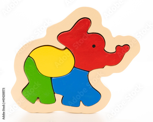 Wooden elephant puzzle on white background
