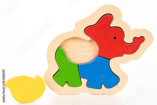 Wooden elephant puzzle on white background