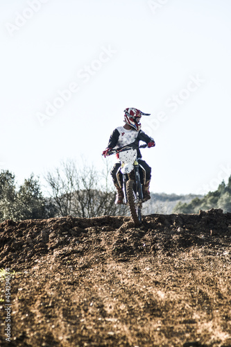 Boy looking to the side while riding a motocross bike