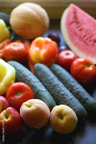 Various colorful summer fruit and vegetable on dark background. Selective focus.