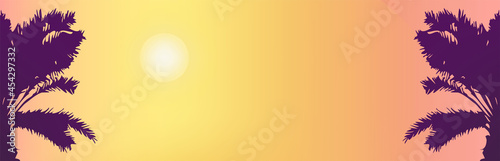 Sunny background of sunrise or sunset on the tropical coast. Silhouette of a two palms tree lit by the sun 