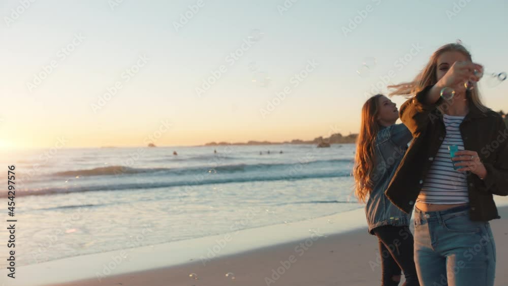 girl friends blowing bubbles on beach at sunset having fun summer playing by the sea enjoying friendship girl friends blowing bubbles on beach at sunset having fun summer playing by the sea enjoying friendship