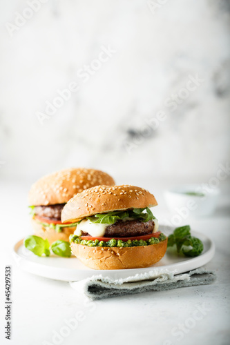 Traditional homemade beef burgers with pesto sauce