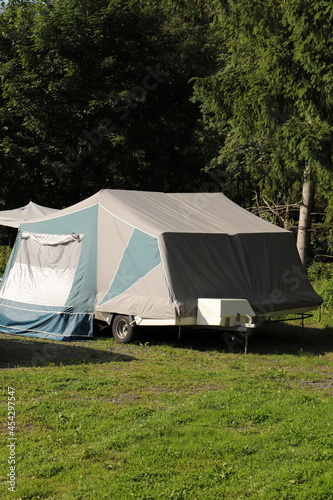 an old folding caravan on a campsite 