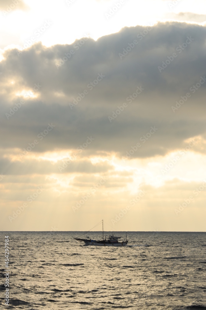 cloudy sunset and boat on sea