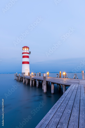 Wooden Pier with Lighthouse in Podersdorf on Lake Neusiedler in Austria at Sunrise.