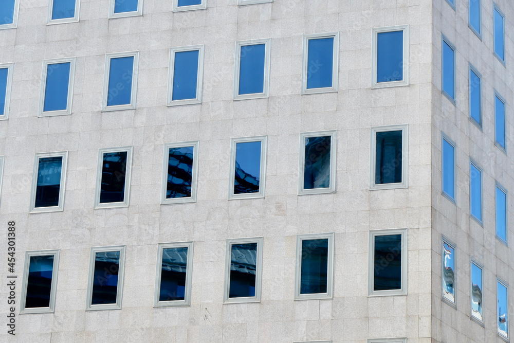 Corner of minimal building facade with simple glass windows Corner of minimal building facade with simple glass windows