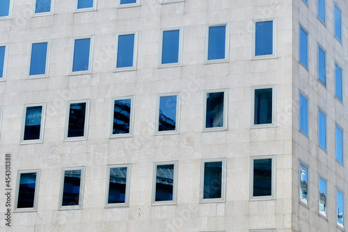 Corner of minimal building facade with simple glass windows