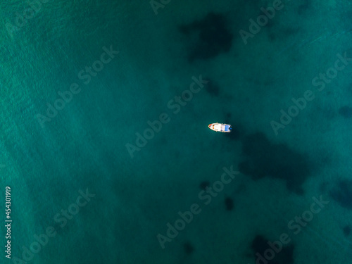 Sailboat Sail on Blue Ocean Waters. Top Down Drone View
