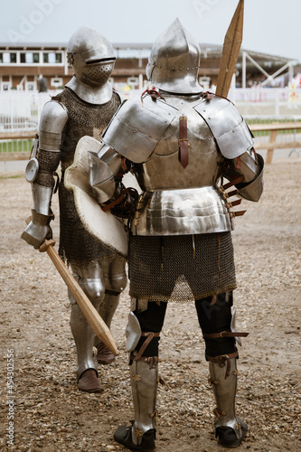 Two medieval knights in heavy armor are ready for battle. Modern reconstruction of ancient traditions and customs
