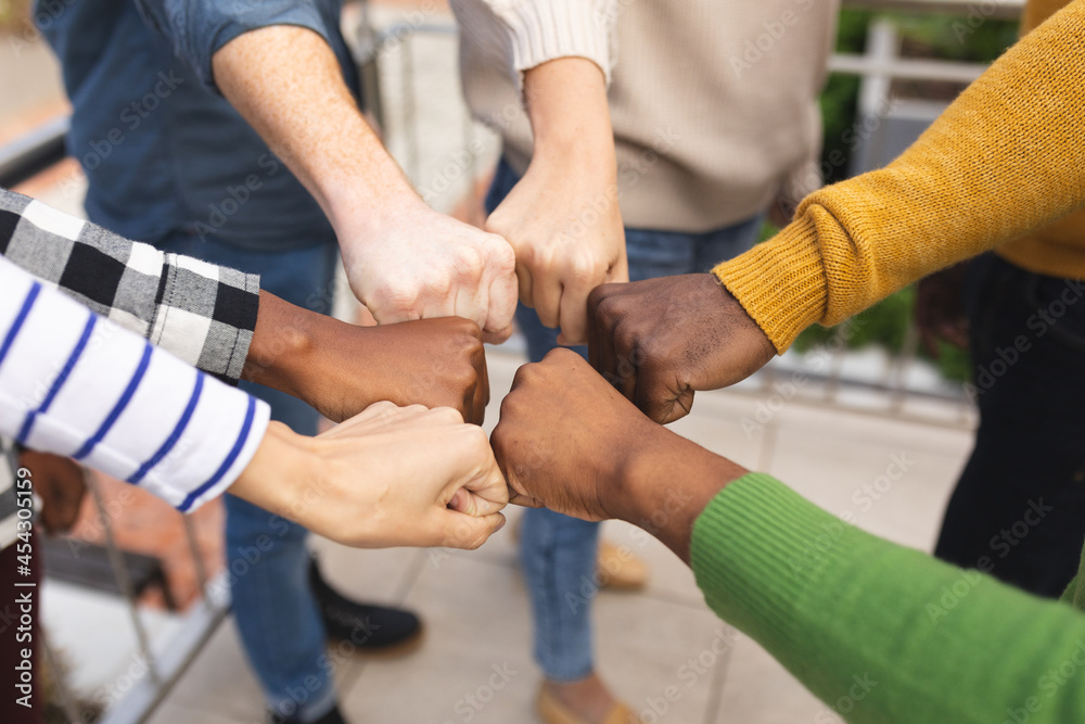Diverse male and female colleagues at work, teaming up Diverse male and female colleagues at work, teaming up