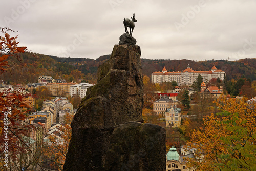Karlovy Vary famous chamois statue, symbol of spa town in autumn atmosphere with yellow coloured trees, Karlovy Vary, Czech Republic photo