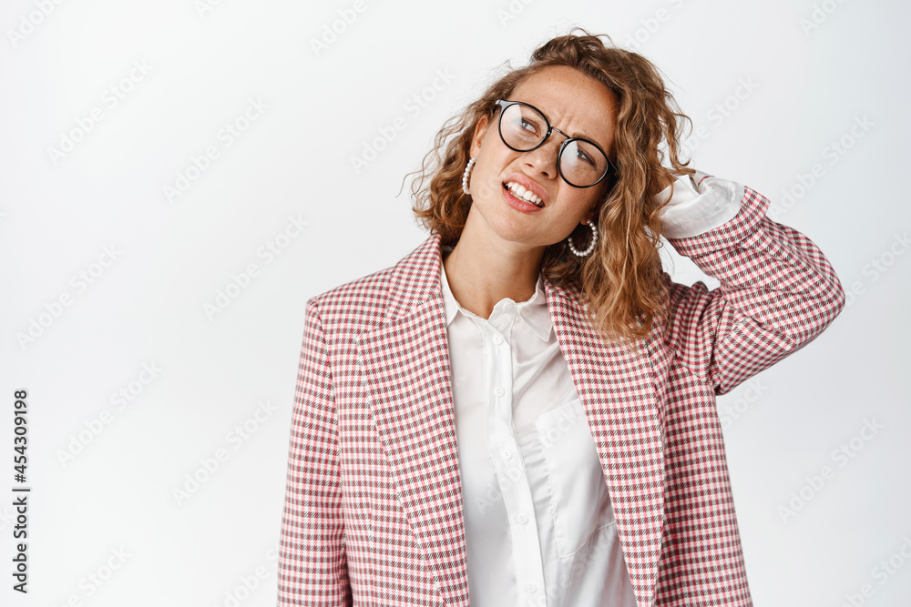 Confused business woman scratching head and looking puzzled, cant understand something, being questioned, standing against white background Confused business woman scratching head and looking puzzled, cant understand something, being questioned, standing against white background
