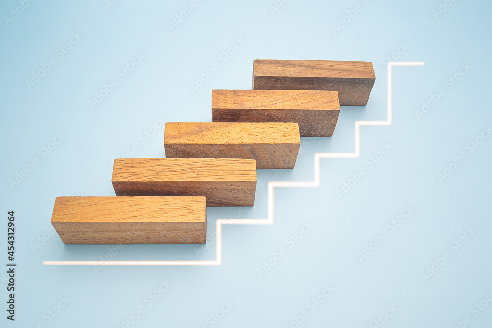 Business growth and investment concept. Wooden blocks stair with white line effect isolated on a blue background for connecting to goal success