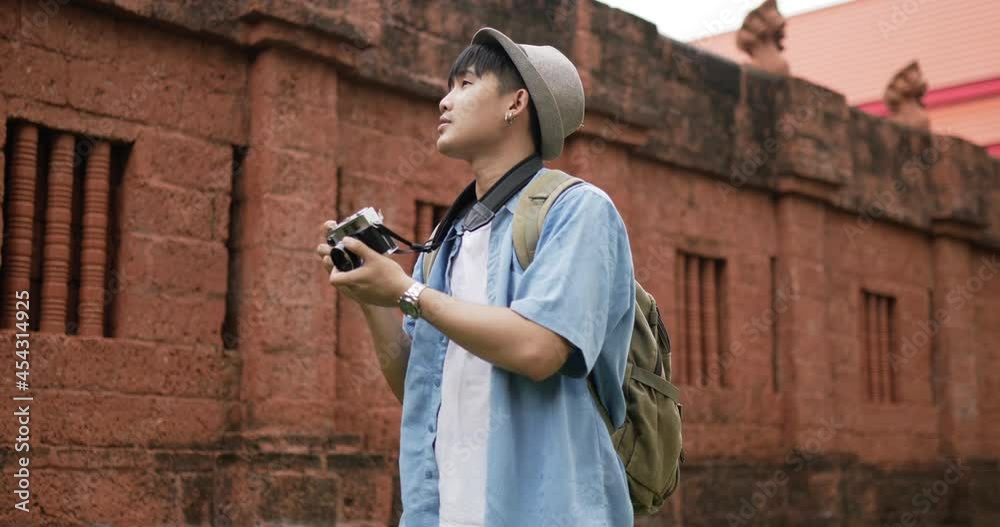 Man takes a photo and visits ancient temple Man takes a photo and visits ancient temple