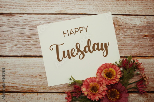 Happy Tuesday card typography text with flower bouquet on wooden background