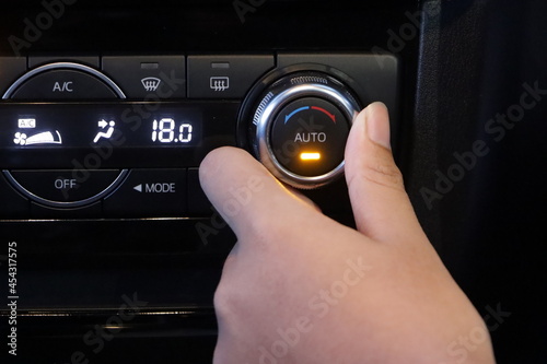 Turns on air conditioning in the car. Modern car interior photo