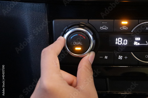 Turns on air conditioning in the car. Modern car interior photo