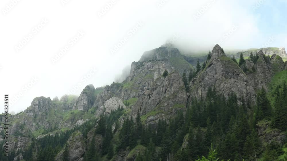 Beautiful rocky mountain landscape with clouds passing over the peaks Beautiful rocky mountain landscape with clouds passing over the peaks