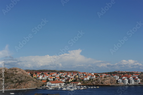 Scenic panorama of Kungshamn waterfront (Sotenäs, Västra Götaland, Sweden) with boats, yachts and houses on a sunny day in summer