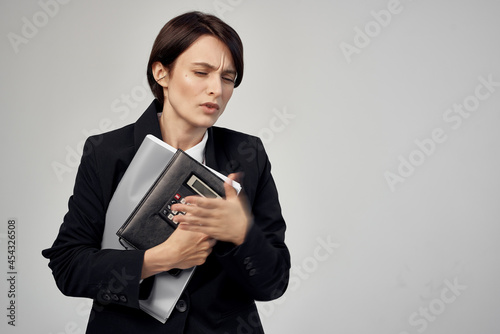 Business woman in glasses black jacket documents emotions work