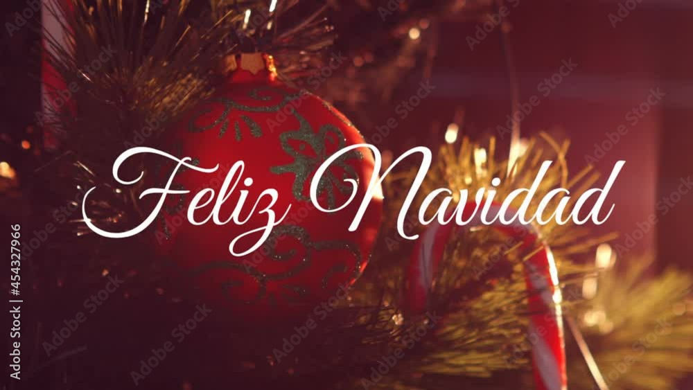 Animation of feliz navidad christmas greetings text over christmas red bauble decoration