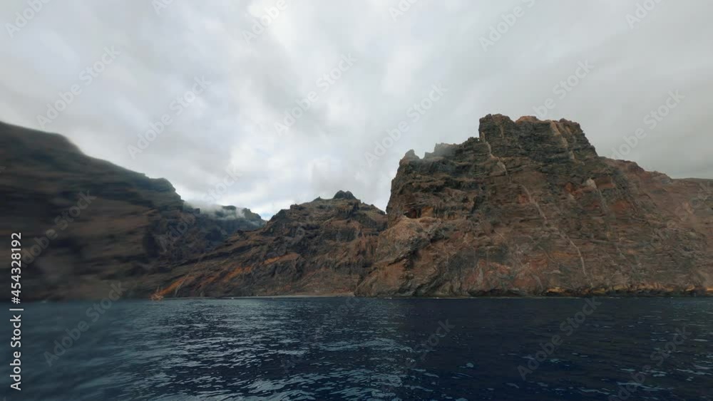 Inspiring shot of wonderful rough cliffs with spectacular sharp rocks. Mountains and seaside. Beautiful travel views sailing on sea water. Inspiring shot of wonderful rough cliffs with spectacular sharp rocks. Mountains and seaside. Beautiful travel views sailing on sea water.