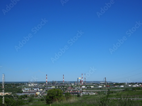 Oil refinery and petrochemical architecture plant industrial with blue sky background, White oil and gas refinery tank, Oil refinery plant from industry zone business power and energy petroleum. © Yulia