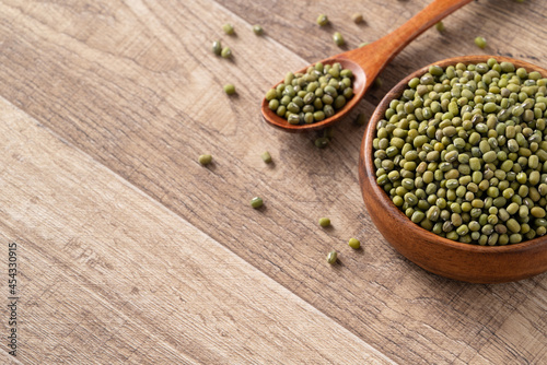 Close up of raw mung bean on wooden table background.
