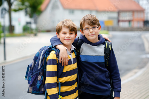 Tablou pe pânză Two kid boys with backpack or satchel